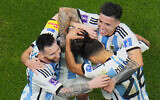 Argentina players celebrate with Argentina's Lionel Messi, left, who scored his side's first goal with a penalty shot during the World Cup semifinal soccer match between Argentina and Croatia at the Lusail Stadium in Lusail, Qatar, December 13, 2022. (AP Photo/Hassan Ammar)