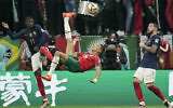 Morocco's Jawad El Yamiq, center, attempts a shot at goal during the World Cup semifinal soccer match between France and Morocco at the Al Bayt Stadium in Al Khor, Qatar, Wednesday, Dec. 14, 2022. (AP Photo/Christophe Ena)