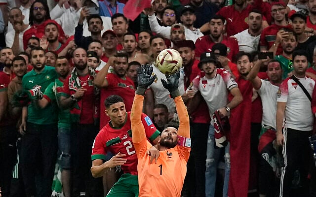 France's goalkeeper Hugo Lloris and Morocco's Achraf Hakimi challenge for the ball in front of Morocco's supporters during the World Cup semifinal soccer match between France and Morocco at the Al Bayt Stadium in Al Khor, Qatar, Wednesday, Dec. 14, 2022. (AP Photo/Martin Meissner) France's goalkeeper Hugo Lloris and Morocco's Achraf Hakimi challenge for the ball in front of Morocco's supporters during the World Cup semifinal soccer match between France and Morocco at the Al Bayt Stadium in Al Khor, Qatar, Wednesday, Dec. 14, 2022. (AP Photo/Martin Meissner)