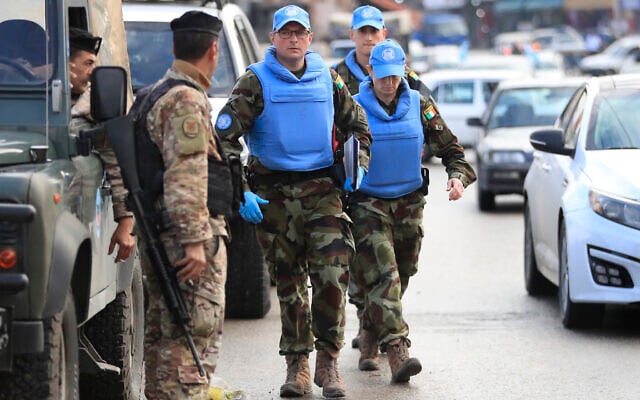 Irish UN peacekeepers pass a Lebanese soldier, left, as they arrive to investigate the scene where unidentified open gunfire came on a UN peacekeeper convoy in the al-Aqbiya village, south Lebanon, December 15, 2022. (AP Photo/Mohammed Zaatari) Irish UN peacekeepers pass a Lebanese soldier, left, as they arrive to investigate the scene where unidentified open gunfire came on a UN peacekeeper convoy in the al-Aqbiya village, south Lebanon, December 15, 2022. (AP Photo/Mohammed Zaatari)