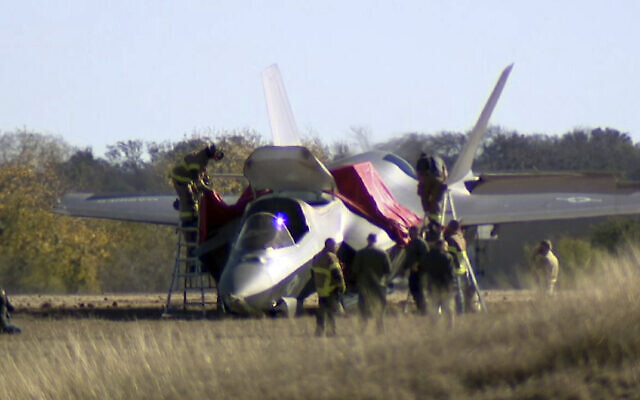 This image taken from video provided by KDFW, shows emergency personnel at the scene after a fighter jet crash landed at Naval Air Station Joint Reserve Base in Fort Worth, Texas, Thursday, Dec. 15, 2022. The pilot safely ejected from a plane after a failed landing. (KDFW via AP) This image taken from video provided by KDFW, shows emergency personnel at the scene after a fighter jet crash landed at Naval Air Station Joint Reserve Base in Fort Worth, Texas, Thursday, Dec. 15, 2022. The pilot safely ejected from a plane after a failed landing. (KDFW via AP)