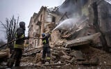 Ukrainian State Emergency Service firefighters work to extinguish a fire at the building which was destroyed by a Russian attack in Kryvyi Rih, Ukraine, Dec. 16, 2022 (AP Photo/Evgeniy Maloletka)