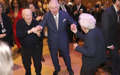 Britain's King Charles III dances during a visit to the JW3 Jewish community centre in London, Friday Dec. 16, 2022, as the Jewish community prepares to celebrate Chanukah. (Ian Vogler/Pool via AP)