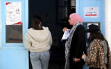 Tunisians line up to cast their ballots at a polling station in Tunis, December 17, 2022. AP/Hassene Dridi)