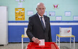 Tunisia's President Kais Saied casts his ballot as he participates in the legislative elections in Tunis, December 17, 2022. (AP/Slim Abid)
