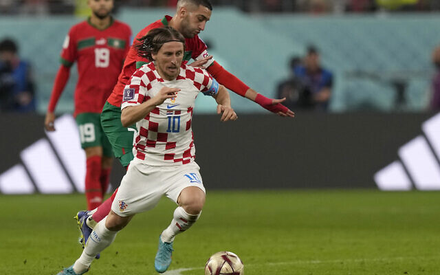 Croatia's Luka Modric, front, duels for the ball with Morocco's Hakim Ziyech during the World Cup third-place playoff soccer match between Croatia and Morocco at Khalifa International Stadium in Doha, Qatar, December 17, 2022. (AP Photo/Frank Augstein) Croatia's Luka Modric, front, duels for the ball with Morocco's Hakim Ziyech during the World Cup third-place playoff soccer match between Croatia and Morocco at Khalifa International Stadium in Doha, Qatar, December 17, 2022. (AP Photo/Frank Augstein)