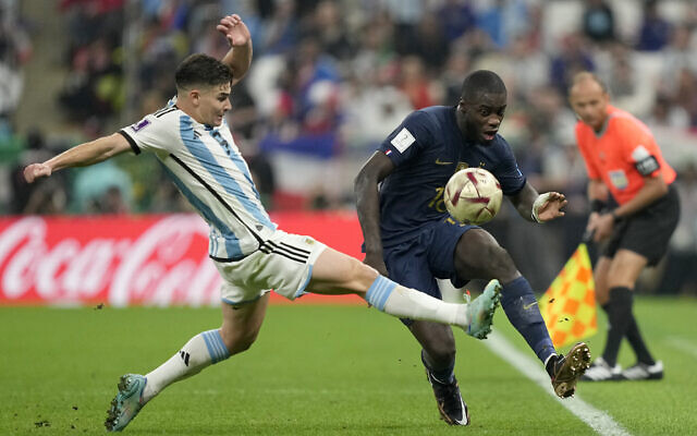 Argentina's Julian Alvarez, left, vies for the ball with France's Dayot Upamecano during the World Cup final soccer match between Argentina and France at the Lusail Stadium in Lusail, Qatar, December 18, 2022. (AP Photo/Martin Meissner)