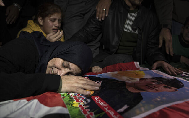 Mohammed al-Shaer's mother on his coffin during his funeral in Rafah, in the southern Gaza Strip, December 18, 2022. (AP Photo/ Fatima Shbair) Mohammed al-Shaer's mother on his coffin during his funeral in Rafah, in the southern Gaza Strip, December 18, 2022. (AP Photo/ Fatima Shbair)