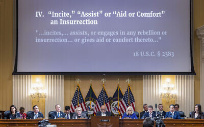 An image with information about the criminal referral of former US President Donald Trump to the Department of Justice is displayed as the House select committee investigating the Jan. 6 attack on the US Capitol holds its final meeting on Capitol Hill in Washington, Dec. 19, 2022. (Jim Lo Scalzo/Pool Photo via AP)