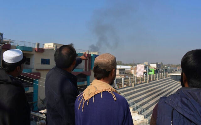 Local residents watch smoke rising from a counter-terrorism center after security forces starting to clear the compound seized earlier by Pakistani Taliban members in Bannu, Khyber Pakhtunkhwa province, Dec. 20, 2022. (AP Photo/Muhammad Hasib) Local residents watch smoke rising from a counter-terrorism center after security forces starting to clear the compound seized earlier by Pakistani Taliban members in Bannu, Khyber Pakhtunkhwa province, Dec. 20, 2022. (AP Photo/Muhammad Hasib)