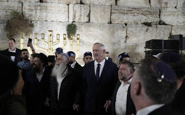 Defense Minister Benny Gantz, second from right, arrives for a Hanukkah candle lighting at the Western Wall in Jerusalem, December 20, 2022. (AP Photo/Tsafrir Abayov) Defense Minister Benny Gantz, second from right, arrives for a Hanukkah candle lighting at the Western Wall in Jerusalem, December 20, 2022. (AP Photo/Tsafrir Abayov)