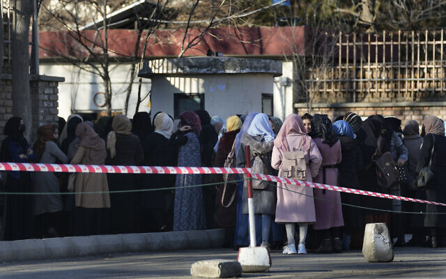 Afghan students line up at one of Kabul University's gates in Kabul, Afghanistan, February 26, 2022. (Hussein Malla/AP) Afghan students line up at one of Kabul University's gates in Kabul, Afghanistan, February 26, 2022. (Hussein Malla/AP)
