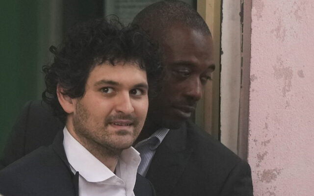 FTX founder Sam Bankman-Fried, is escorted from the Magistrate Court in Nassau, Bahamas, December 21, 2022, after agreeing to be extradited to the US. (AP Photo/Rebecca Blackwell) FTX founder Sam Bankman-Fried, is escorted from the Magistrate Court in Nassau, Bahamas, December 21, 2022, after agreeing to be extradited to the US. (AP Photo/Rebecca Blackwell)