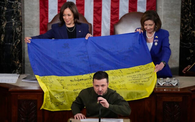 US Vice President Kamala Harris and House Speaker Nancy Pelosi, right, react as Ukrainian President Volodymyr Zelensky presents lawmakers with a Ukrainian flag autographed by front-line troops in Bakhmut, in Ukraine's contested Donetsk province, as he addresses a joint meeting of Congress on Capitol Hill in Washington, December 21, 2022. (AP Photo/Jacquelyn Martin) US Vice President Kamala Harris and House Speaker Nancy Pelosi, right, react as Ukrainian President Volodymyr Zelensky presents lawmakers with a Ukrainian flag autographed by front-line troops in Bakhmut, in Ukraine's contested Donetsk province, as he addresses a joint meeting of Congress on Capitol Hill in Washington, December 21, 2022. (AP Photo/Jacquelyn Martin)