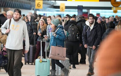Travelers queue up to check in at the Southwest Airlines counter in Denver International Airport after a winter storm swept over the country packing snow combined with Arctic cold, which created chaos for people trying to reach their destinations before the Christmas holiday, December 23, 2022, in Denver. (AP Photo/David Zalubowski)