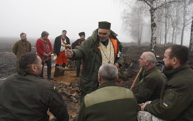 A chaplain blesses Ukraine's National Guard soldiers to mark Christmas at their positions close to the Russian border near Kharkiv, Ukraine, Dec. 24 2022. (AP Photo/Andrii Marienko) A chaplain blesses Ukraine's National Guard soldiers to mark Christmas at their positions close to the Russian border near Kharkiv, Ukraine, Dec. 24 2022. (AP Photo/Andrii Marienko)