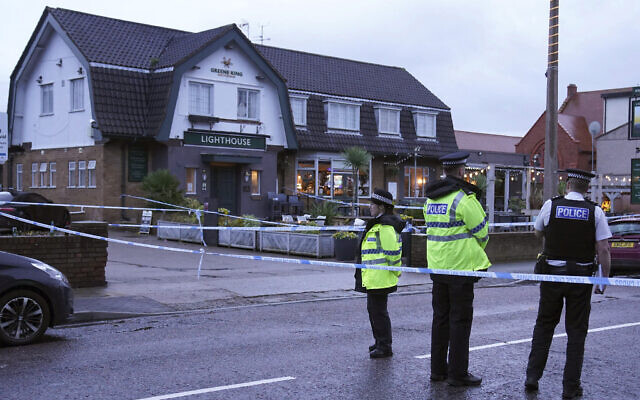 Police officers stand on duty at the Lighthouse Inn in Wallasey Village, near Liverpool, England, Dec. 25, 2022. (Peter Byrne/PA via AP) Police officers stand on duty at the Lighthouse Inn in Wallasey Village, near Liverpool, England, Dec. 25, 2022. (Peter Byrne/PA via AP)