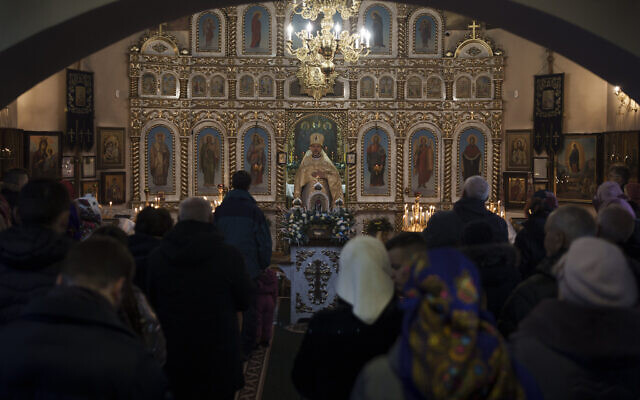 Ukrainians attend a Christmas mass at an Orthodox Church in Bobrytsia, outskirts of Kyiv, Ukraine, Dec. 25, 2022. (AP Photo/Felipe Dana)