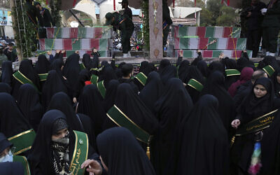 Mourners attend a funeral procession for a group of unknown Iranian soldiers killed during the 1980-88 Iran-Iraq war whose remains were recently recovered in the battlefields, in Tehran, Dec. 27, 2022. (AP Photo/Vahid Salemi)