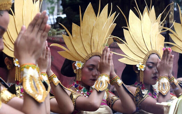 Women dancers pray before their perform during culture parade to bid farewell to 2022 and welcoming 2023 in Bali, Indonesia on December 31, 2022. (AP Photo/Firdia Lisnawati) Women dancers pray before their perform during culture parade to bid farewell to 2022 and welcoming 2023 in Bali, Indonesia on December 31, 2022. (AP Photo/Firdia Lisnawati)