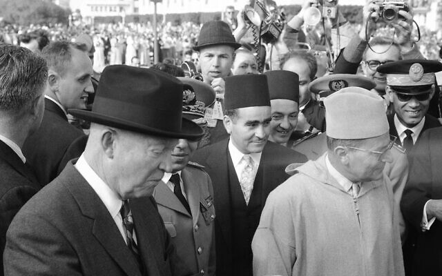 US President Dwight Eisenhower holds bowl of milk and dates, a traditional Arab dish, which he received on arriving at town hall in Casablanca, Morocco on December 22, 1959. At right is King Mohammed V of Morocco. (AP Photo)