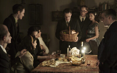 The Frank, van Pels, and Gies families celebrate Hanukkah in a scene from 'A Small Light' slated to air on National Geographic and Disney+ in 2023. (Dusan Martincek/National Geographic for Disney)