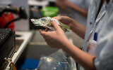 Illustrative -- Pharmacists supply patients with prescribed medical marijuana in Tel Aviv, on April 10, 2016 (Hadas Parush/Flash90)