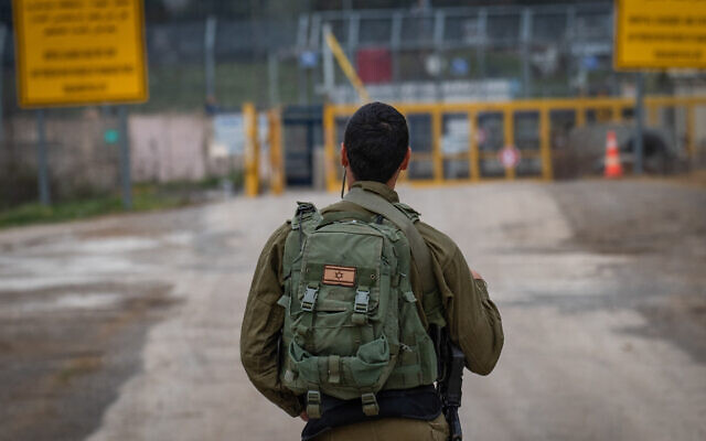 Illustrative: An Israeli soldier stands guard on the Israel's side of the Quneitra crossing on the Syrian border, in the Golan Heights, March 23, 2019. (Basel Awidat/Flash90) Illustrative: An Israeli soldier stands guard on the Israel's side of the Quneitra crossing on the Syrian border, in the Golan Heights, March 23, 2019. (Basel Awidat/Flash90)