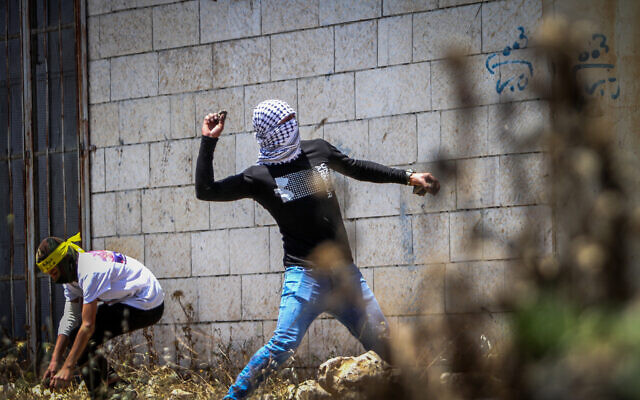 Illustrative: Palestinians clash with Israeli security forces during a protest in the village of Kfar Qaddum, near the West Bank city of Nablus, May 20, 2022. (Nasser Ishtayeh/Flash90) Illustrative: Palestinians clash with Israeli security forces during a protest in the village of Kfar Qaddum, near the West Bank city of Nablus, May 20, 2022. (Nasser Ishtayeh/Flash90)