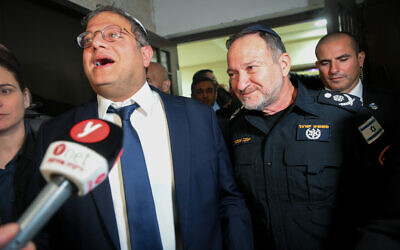 Otzma Yehudit chief Itamar Ben Gvir (L) and Israel Police Commissioner Kobi Shabtai outside the Bat Mitzah of Ben Gvir's daughter, in the West Bank settlement of Kiryat Arba, December 8, 2022. (Arie Leib Abrams/Flash90)