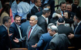 Likud Head MK Benjamin Netanyahu surrounded by MKs after a vote for the new Knesset speaker at the Israeli parliament in Jerusalem, on December 13, 2022. (Yonatan Sindel/Flash90)