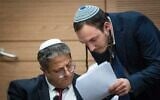 Otzma Yehudit party chief Itamar Ben Gvir (L) speaks with his chief of staff Chanamel Dorfman, during a Knesset special committee to discuss his proposed Police Ordinance changes, December 18, 2022. (Yonatan Sindel/ Flash90)