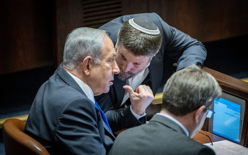 Likud leader MK Benjamin Netanyahu (left) speaks with Religious Zionism party head MK Bezalel Smotrich during a vote in the Knesset, December 20, 2022. (Yonatan Sindel/Flash90) Likud leader MK Benjamin Netanyahu (left) speaks with Religious Zionism party head MK Bezalel Smotrich during a vote in the Knesset, December 20, 2022. (Yonatan Sindel/Flash90)