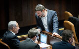 Likud leader MK Benjamin Netanyahu (left) speaks with Religious Zionism party head MK Bezalel Smotrich during a vote in the Knesset, December 20, 2022. (Yonatan Sindel/Flash90)