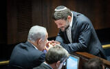 Religious Zionism party head MK Bezalel Smotrich (right) speaks with Likud leader Benjamin Netanyahu during a vote in the Knesset on December 20, 2022. (Yonatan Sindel/Flash90)