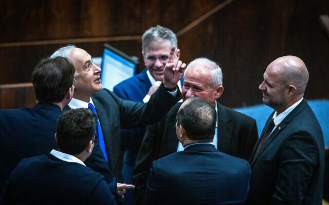 Likud leader MK Benjamin Netanyahu with fellow Likud MKs in the Knesset, on December 28, 2022. (Olivier Fitoussi/Flash90) Likud leader MK Benjamin Netanyahu with fellow Likud MKs in the Knesset, on December 28, 2022. (Olivier Fitoussi/Flash90)