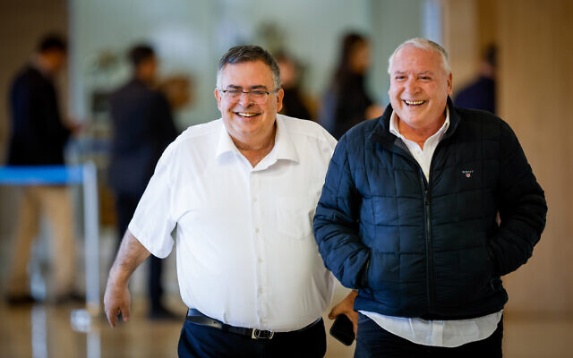 Likud party members David Amsalem (right) and David Bitan arrive for a Likud faction meeting at the Knesset in Jerusalem on December 28, 2022. (Olivier Fitoussi/Flash90)