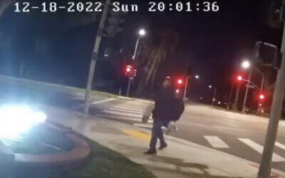 A screenshot from surveillance video shows a man vandalizing a menorah in the Southern California city of Beverly Hills, December 18, 2022. (YouTube screenshot;  used in accordance with Clause 27a of the Copyright Law)