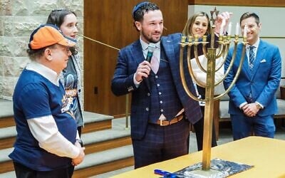Houston Astros third baseman Alex Bregman leads Congregation Beth Yeshurun in the Hanukkah blessing on December 21, 2022. (Daniel Bissonnet/Houston Jewish Herald-Voice)