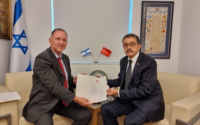 Sakir Ozkan Torunlar (right) presents a copy of his letter of credence to Gil Haskel, the Foreign Ministry's chief of state protocol, December 1, 2022 (Foreign Ministry) Sakir Ozkan Torunlar (right) presents a copy of his letter of credence to Gil Haskel, the Foreign Ministry's chief of state protocol, December 1, 2022 (Foreign Ministry)