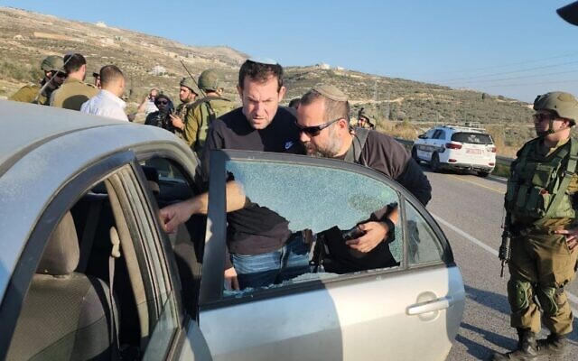 Samaria Regional Council chair Yossi Dagan inspects damage caused to an Israeli-owned car following a shooting attack near the Havat Gilad outpost in the northern West Bank, December 16, 2022. (Roi Hadi/Samaria Reigonal Council) Samaria Regional Council chair Yossi Dagan inspects damage caused to an Israeli-owned car following a shooting attack near the Havat Gilad outpost in the northern West Bank, December 16, 2022. (Roi Hadi/Samaria Reigonal Council)