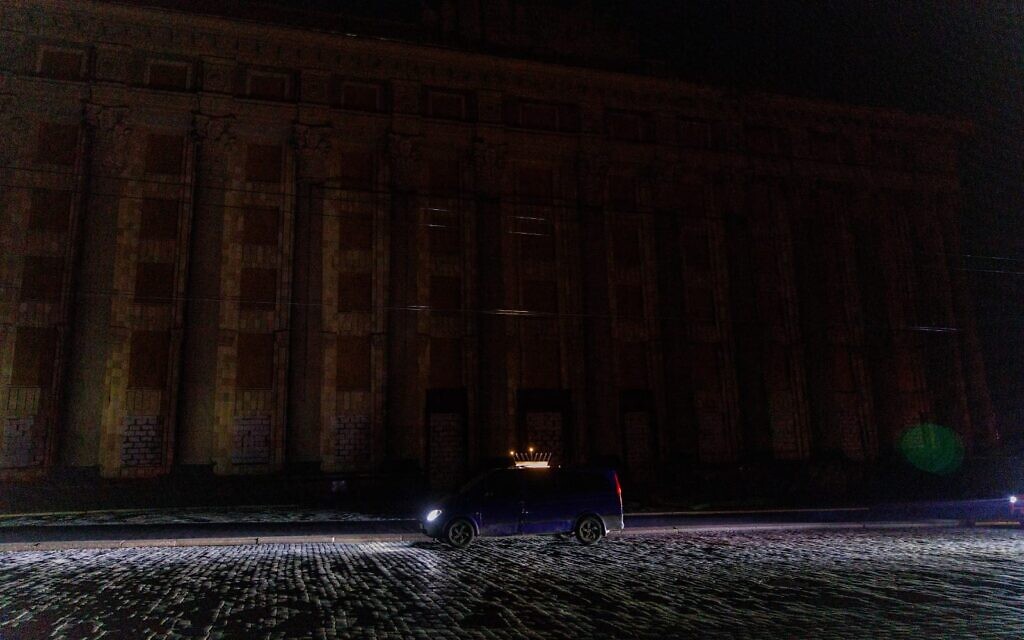 A car with a menorah drives through a darkened Kharkiv, Ukraine, on the first night of Hanukkah, December 18, 2022 (courtesy Kharkiv Choral Synagogue)