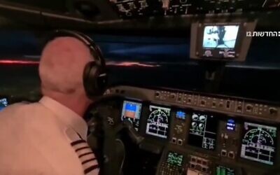 A screengrab from a video aired on Channel 12 showing the Israeli pilot operating the Arkia Airlines flight carrying Israeli President Isaac Herzog back from Abu Dhabi to Israel over Saudi airspace, Tuesdau December 6, 2022. (Screen capture/Channel 12, used in accordance with Clause 27a of the Copyright Law)