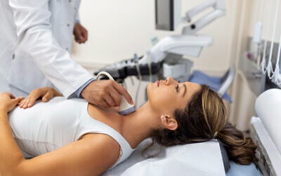 Illustrative: a doctor carrying out checks for an autoimmune thyroid disease. (swpispix; iStock by Getty Images)