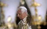 File: Then-pope Benedict XVI prays in front of the Stone of Anointing, where Christians believe the body of Jesus was washed before his burial, at the Church of the Holy Sepulchre in the Old City of Jerusalem, May 15, 2009. (YANNIS BEHRAKIS/POOL/AFP)