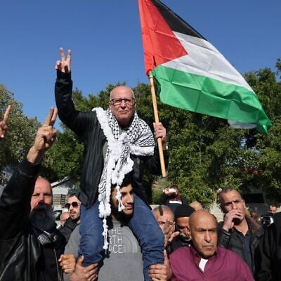 Arab Israeli Karim Younis is carried by friends and relatives following his release after 40 years in an Israeli prison for kidnapping and murdering an Israeli soldier, on January 5, 2023, in the northern Israeli town of 'Ara. (AHMAD GHARABLI / AFP)