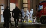 Agents wearing protective suits examine substances on the premises of the fire brigade in Castrop-Rauxel, western Germany, following arrests on suspicion of preparing an 'Islamist attack' using cyanide and ricin,  on January 8, 2023. (Christoph Reichwein / DPA / AFP)