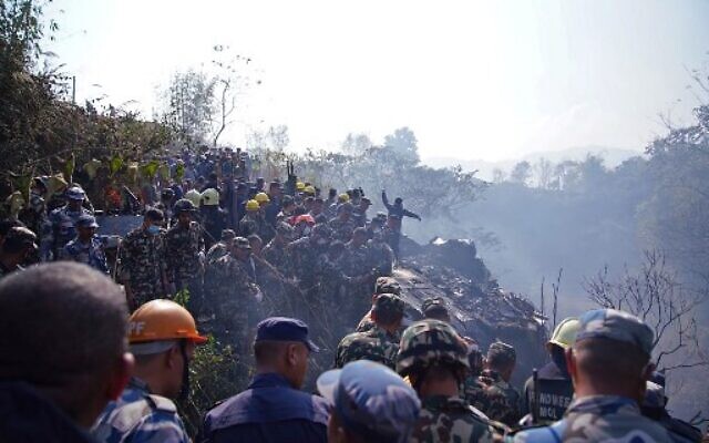 Rescuers gather at the site of a plane crash in the resort town of Pokhara, Nepal, January 15, 2023. (Yunish Gurung/AFP) Rescuers gather at the site of a plane crash in the resort town of Pokhara, Nepal, January 15, 2023. (Yunish Gurung/AFP)