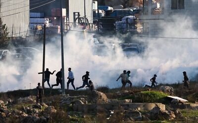 Israeli forces fire tear gas to disperse Palestinian demonstrators during clashes near Ramallah on January 26, 2023. (Ahmad Gharabli / AFP) Israeli forces fire tear gas to disperse Palestinian demonstrators during clashes near Ramallah on January 26, 2023. (Ahmad Gharabli / AFP)