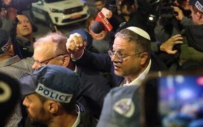 National Security Minister Itamar Ben Gvir speaks to onlookers at the scene of a terror attack in Jerusalem's Neve Yaakov neighborhood, on January 27, 2023. (Ahmad Gharabli/AFP)